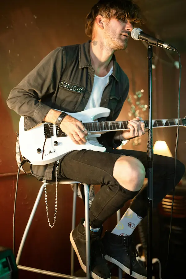 A guitarist performs live